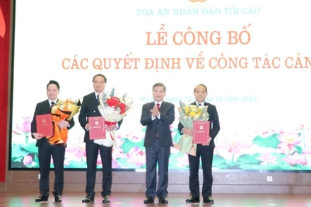 Chánh án Tòa án nhân dân tối cao Lê Minh Trí trao quyết định và tặng hoa chúc mừng các đồng chí được bổ nhiệm.