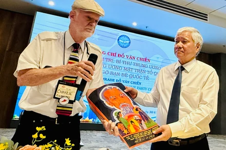 Ông Charles Leslie Clements tặng bức tranh vẽ về Chủ tịch Hồ Chí Minh cho đồng chí Đỗ Văn Chiến.