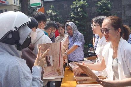 Lãnh đạo và cán bộ, công nhân viên Cơ quan đại diện Báo Nhân Dân khu vực miền nam phát phụ san đến tay bạn đọc. (Ảnh: THẾ ANH)