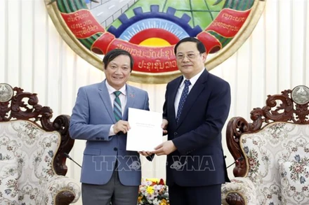 Đại sứ Việt Nam tại Lào Nguyễn Bá Hùng trao cho Thủ tướng Lào Sonexay Siphandone thư của Tổng Bí thư Nguyễn Phú Trọng gửi chúc mừng sinh nhật nguyên Chủ tịch Khamtai Siphandone. (Ảnh: Phạm Kiên - Phóng viên TTXVN tại Lào) 