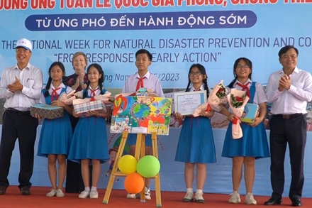 Đại biểu trao quà tặng học sinh đoạt giải các cuộc thi hưởng ứng chống thiên tai.