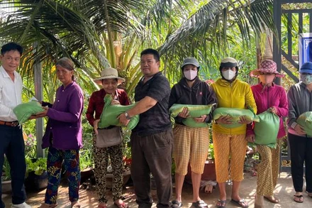 Đại diện nhà hảo tâm trao quà cho các hộ dân có hoàn cảnh khó khăn. (Ảnh: HOÀNG TRUNG)