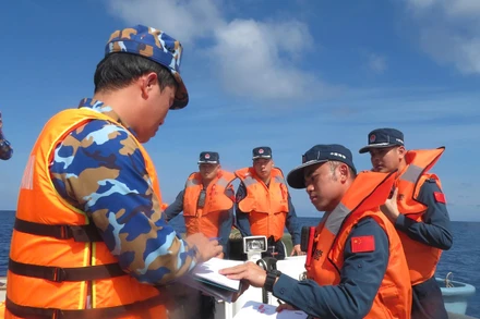 Hải quân Trung Quốc và Việt Nam ký hồ sơ bàn giao 2 ngư dân gặp nạn trên biển. 