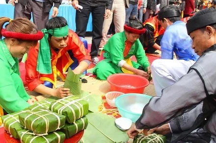 Các nghệ nhân thực hiện phần thi gói bánh chưng.