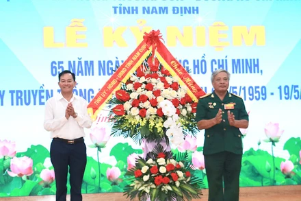 Đồng chí Nguyễn Phùng Hoan, Phó Chủ tịch Thường trực Hội đồng nhân dân tỉnh Nam Định tặng hoa chúc mừng Hội Truyền thống Trường Sơn-Đường Hồ Chí Minh tỉnh Nam Định.