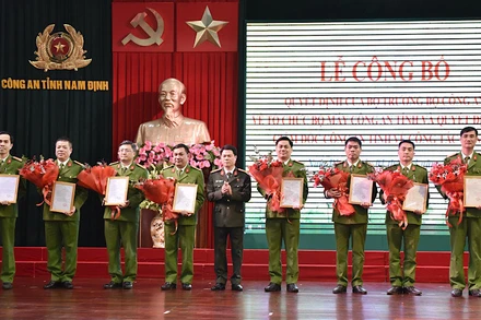 Đại tá Nguyễn Hữu Mạnh, Giám đốc Công an tỉnh Nam Định trao quyết định, tặng hoa chúc mừng các đồng chí nhận công tác mới. 