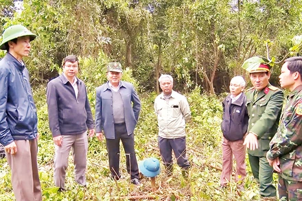 Cán bộ địa phương thuyết phục người dân đồng thuận di dời mồ mả để làm đường cao tốc.