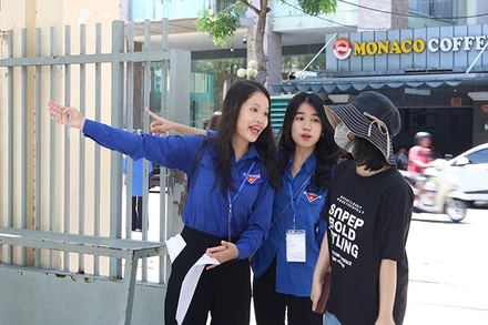 Tình nguyện viên hỗ trợ thí sinh vào vị trí phòng thi.