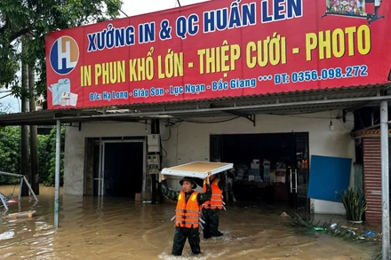 Cán bộ, chiến sĩ Trung đoàn 18, Sư đoàn 325 giúp nhân dân thôn Hạ Long, xã Giáp Sơn, huyện Lục Ngạn, tỉnh Bắc Giang, chuyển đồ đạc đến nơi an toàn. 