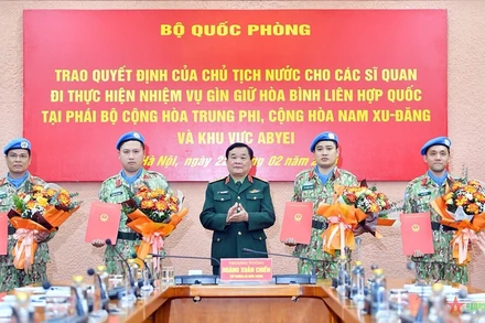 Thượng tướng Hoàng Xuân Chiến thừa ủy quyền của Chủ tịch nước trao Quyết định của Chủ tịch nước cho 4 sĩ quan đi làm nhiệm vụ gìn giữ hòa bình Liên hợp quốc. (Ảnh: Báo Quân đội nhân dân)