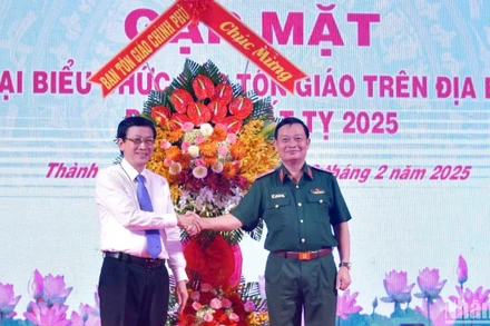 Lãnh đạo Ban Tôn giáo Chính phủ tặng hoa chúc mừng Bộ Tư lệnh Quân khu tại buổi gặp mặt.