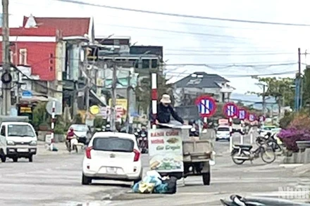 Lực lượng chức năng tháo dỡ các biển báo cấm đỗ xe ngày chẵn trên đoạn đường 1km, qua xã Lạc Lâm, huyện Đơn Dương sáng 24/2. (Ảnh: CTV) 