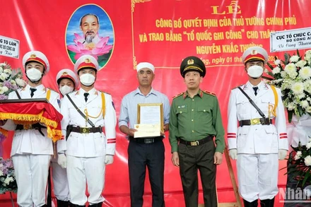 Thiếu tướng Lê Văn Tuyến trao quyết định của Bộ trưởng Công an cho thân nhân liệt sĩ-Trung tá Nguyễn Khắc Thường.