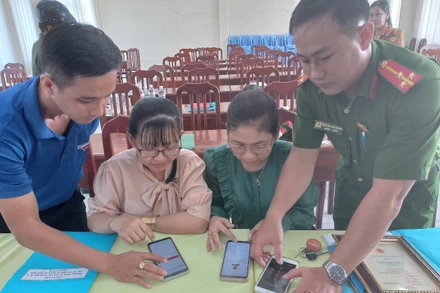 Công an xã Tân Hộ Cơ phối hợp Đoàn Thanh niên trên địa bàn xã hướng dẫn người dân cài đặt ứng dụng VNeiD trên điện thoại thông minh.