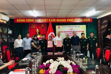 Đại diện Hội Hỗ trợ gia đình liệt sĩ Việt Nam và các cơ quan chức năng chụp ảnh lưu niệm cùng thân nhân liệt sĩ.