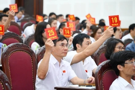 Các đại biểu biểu quyết thông qua Nghị quyết về việc tán thành chủ trương sắp xếp các đơn vị hành chính cấp xã trên địa bàn thành phố Vinh.