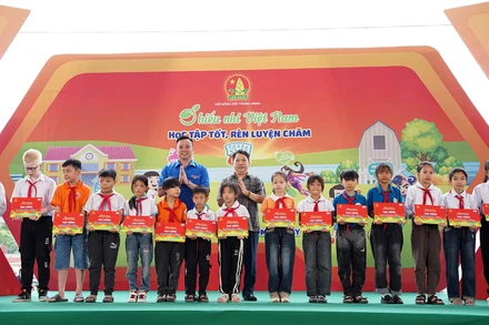Phó Chủ tịch Hội đồng Đội Trung ương, Giám đốc Trung tâm Hỗ trợ và Phát triển thiếu nhi Việt Nam Lê Anh Quân (bên trái, hàng sau) cùng đại diện Ban tổ chức Ngày hội trao học bổng tặng thiếu nhi hoàn cảnh khó khăn.