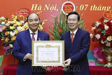 Đồng chí Võ Văn Thưởng trao tặng Huy hiệu 40 năm tuổi Đảng cho đồng chí Nguyễn Xuân Phúc. (Ảnh: Thống Nhất/TTXVN)