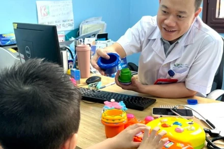 Thạc sĩ, bác sĩ Nguyễn Minh Quyết, Khoa Tâm thần, Bệnh viện Nhi Trung ương khám cho bệnh nhi.