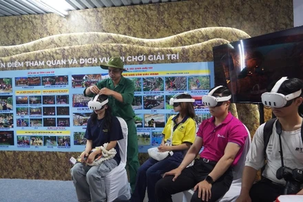 Các bạn trẻ khám phá sản phẩm du lịch mới của Địa đạo Củ Chi thông qua ứng dụng thực tế ảo. (Ảnh: THẾ ANH)