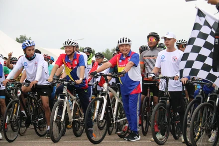 Chủ tịch Quốc hội Lào Saysomphone Phomvihane và Đại sứ Nguyễn Bá Hùng hào hứng tham gia Cuộc đua xe đạp “Đoàn xe của tình đoàn kết”. (Ảnh: Nguyễn Hải Tiến)