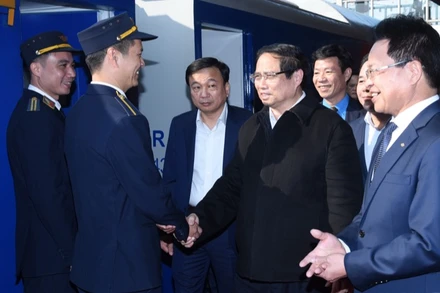 Thủ tướng Phạm Minh Chính hỏi thăm nhân viên ngành đường sắt Việt Nam phục vụ trên "Chuyến tàu Xuân" xuất phát tại ga Hà Nội. (Ảnh: TRẦN HẢI)