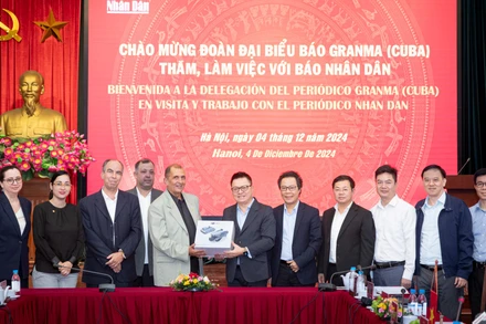 Tổng Biên tập Lê Quốc Minh tặng đại diện đoàn Báo Granma thiết bị flycam phục vụ hoạt động tác nghiệp báo chí. (Ảnh: SƠN TÙNG)