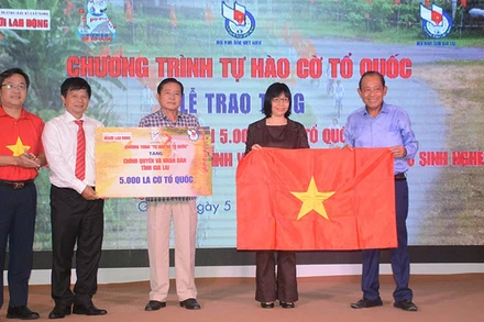 Ông Trương Hòa Bình, nguyên Ủy viên Bộ Chính trị, nguyên Phó Thủ tướng Thường trực Chính phủ (ngoài cùng bên phải); ông Trần Trọng Dũng, Phó Chủ tịch Hội Nhà báo Việt Nam phụ trách phía Nam và ông Lê Cao Cường, Phó Tổng Biên tập Báo Người Lao Động, tặng cờ cho đồng bào, chiến sĩ tỉnh Gia Lai.