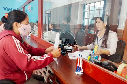 Công chức Trung tâm phục vụ hành chính công tỉnh Kiên Giang giải quyết thủ tục hành chính cho người dân. (Ảnh: QUỐC TRINH)