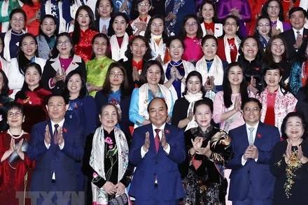 Chủ tịch nước Nguyễn Xuân Phúc, Thủ tướng Chính phủ Phạm Minh Chính, Chủ tịch Quốc hội Vương Đình Huệ, các lãnh đạo, nguyên lãnh đạo Đảng, Nhà nước với các nữ đại biểu. (Ảnh: TTXVN)