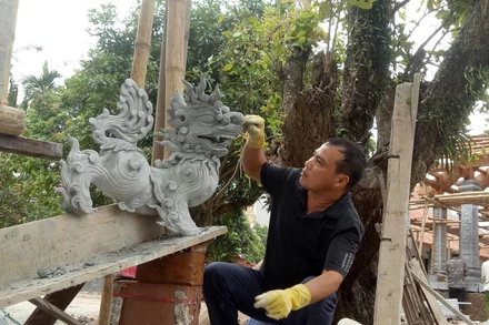 Nghệ nhân Nguyễn Đức Thủy đang tạo tác linh vật.