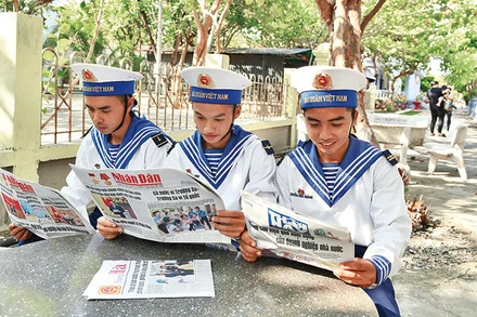 Các chiến sĩ trên đảo Trường Sa (Khánh Hòa) đọc Báo Nhân Dân. Ảnh: ĐĂNG KHOA