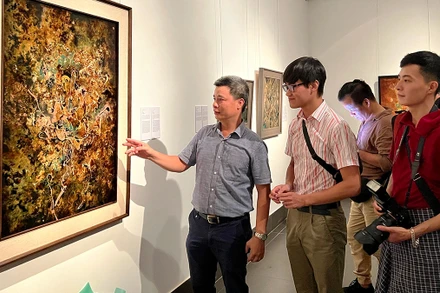 Họa sĩ Triệu Khắc Tiến giới thiệu tác phẩm sơn mài trên vóc “Hoan ca”. 