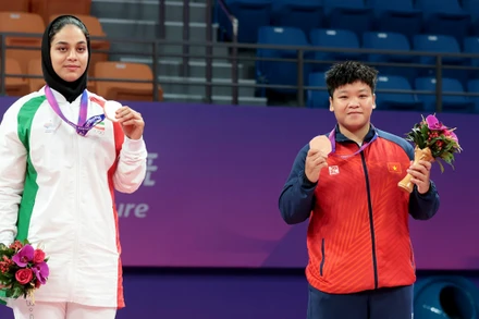 Võ sĩ kurash Phương Quỳnh (bên phải) trên bục nhận HCÐ.