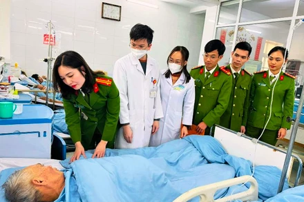 Thành viên đoàn công tác ân cần hỏi thăm sức khỏe bệnh nhân.