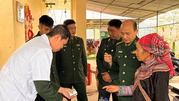Cán bộ quân y Đồn biên phòng Nậm Nhừ cấp thuốc cho bà con người dân tộc thiểu số ở xã Nà Hỳ. 