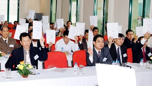 Biểu quyết thông qua các phương án tại đại hội cổ đông của một doanh nghiệp. Ảnh: NGUYỆT ANH