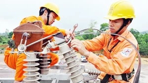 Công nhân điện lực Hà Nội xử lý sự cố đường dây bảo đảm dòng điện được thông suốt. Ảnh: BẮC SƠN