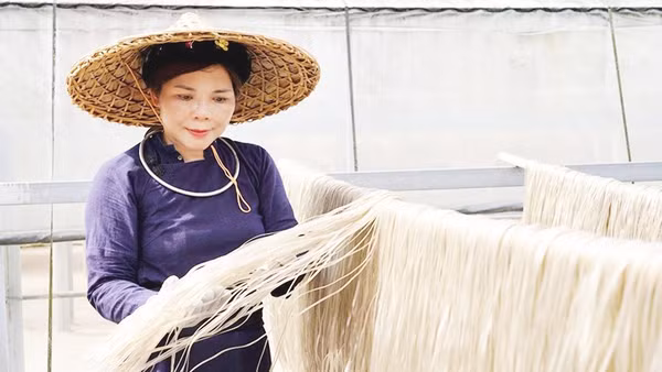 Chị Hoan kiểm tra miến phơi khô tự nhiên dưới nắng. 