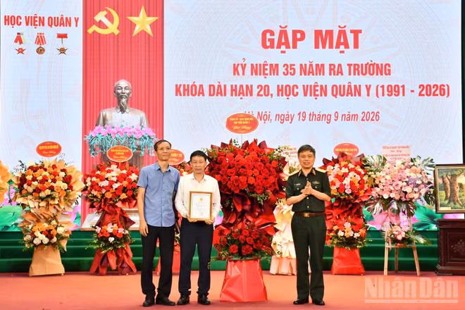 Thiếu tướng, Phó Giáo sư, Tiến sĩ Trần Ngọc Tuấn, Phó Giám đốc Học viện Quân y, thay mặt Đảng ủy, Ban Giám đốc Học viện Quân y tặng hoa chúc mừng Khóa 20. (Ảnh: TUẤN DŨNG)