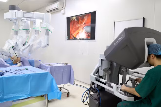 Ê-kíp bác sĩ Bệnh viện K ứng dụng robot phẫu thuật điều trị ung thư cổ tử cung cho người bệnh. (Ảnh nhandan.vn)