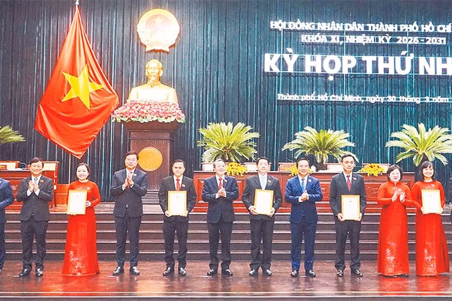 Trao chứng nhận đại biểu đến các đại biểu Hội đồng nhân dân thành phố khóa XI (Ảnh THẾ ANH)
