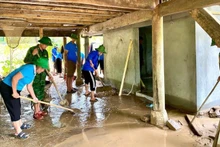 Chi đoàn Đồn Biên phòng Tri Lễ, Hội Liên hiệp Phụ nữ xã Tri Lễ, Nghệ An và Đội sinh viên tình nguyện 2518 Trường Đại học Vinh đến các điểm bị ảnh hưởng bởi lũ lụt hỗ trợ bà con nhân dân sớm ổn định cuộc sống. (Ảnh: Mặt trận Tổ quốc Việt Nam tỉnh Nghệ An)