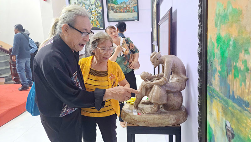 Đại biểu xem các tác phẩm được trưng bày tại triển lãm.