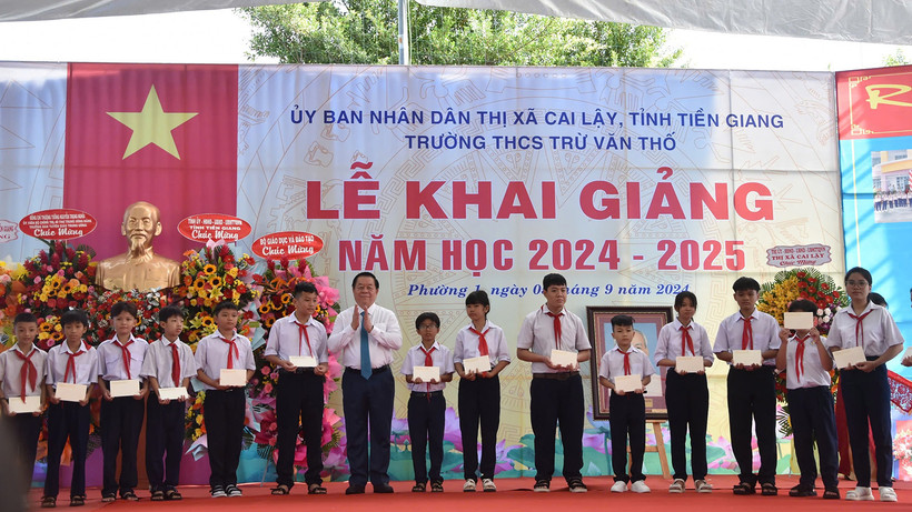 Trưởng Ban Tuyên giáo Trung ương Nguyễn Trọng Nghĩa tặng học bổng cho các em học sinh nghèo nhân dịp lễ khai giảng. 