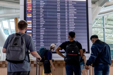 Hành khách xem thông tin trên bảng điện tử tại sân bay quốc tế I Gusti Ngurah Rai ở Bali, Indonesia. (Ảnh: XINHUA)
