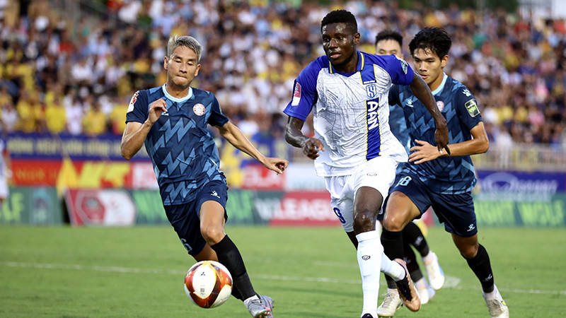 Pha tranh bóng trong trận đấu giữa đội Sông Lam Nghệ An (áo trắng) thắng đội Thành phố Hồ Chí Minh với tỷ số 2-1. (Ảnh TTXVN) 