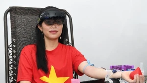 Chị Đoàn Thị Thanh Thủy trải nghiệm hiến máu khi đang đeo kính thực tế ảo tích hợp.