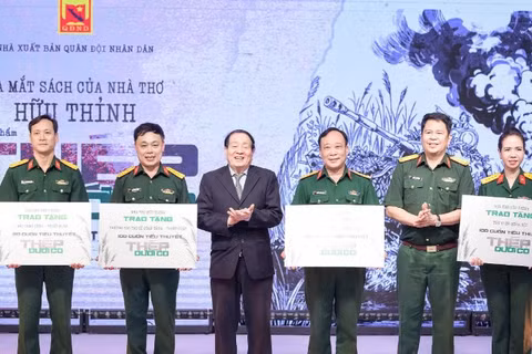 Nhà thơ Hữu Thỉnh và đại diện Nhà xuất bản Quân đội nhân dân tặng sách cho các đơn vị trong quân đội.