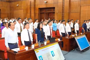 Đại biểu Hội đồng nhân dân tỉnh Điện Biên chào cờ trong chương trình khai mạc Kỳ họp thứ 3, được tổ chức ngày 29/6.